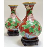 A pair of large Chinese cloisonne vases with carved hardwood stands, the body decorated with