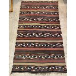 An early 20th century hand woven kuba kilim rug, of typical lineal and geometric design 350cm x