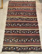 An early 20th century hand woven kuba kilim rug, of typical lineal and geometric design 350cm x