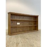 A pine floor standing open bookcase, late 20th century, fitted with two fixed shelves, on a