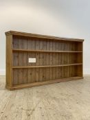 A pine floor standing open bookcase, late 20th century, fitted with two fixed shelves, on a