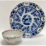 A Kraak style Dutch Delft tin-glazed plate with central roundel depicting a bird, the border with