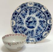 A Kraak style Dutch Delft tin-glazed plate with central roundel depicting a bird, the border with