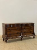 A Victorian mahogany commode or chest of drawers of serpentine outline, fitted with two frieze