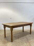 A pine farmhouse style dining table, the rectangular top raised on turned supports H80cm, W184cm,