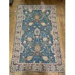 A crewel work chain stictched wall hanging or rug, the blue ground worked in a floral design and