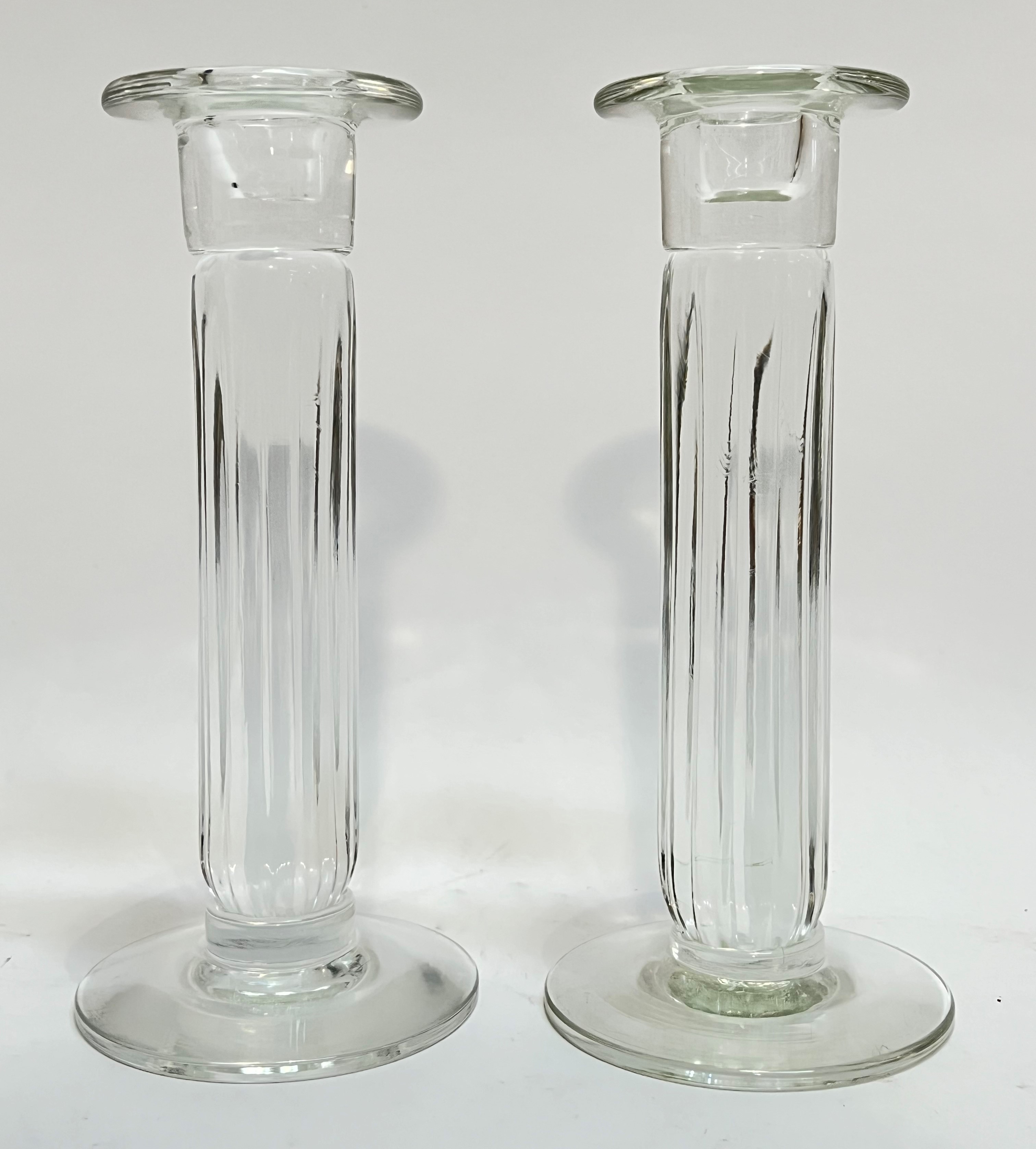 A pair of Lindean Mills fluted column glass candle stick holders (each signed verso) (h- 21cm)