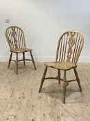 A pair of light ash Windsor chairs, with hoop, spindle and splat back over saddle seat, raised on