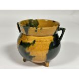 A Scottish Dumore pottery cauldron cache pot with twin handles to side and honey coloured and