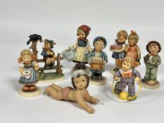 A group of eight German Hummel pottery figures including, Bee Helpful, Postman, Lost Stocking, Happy