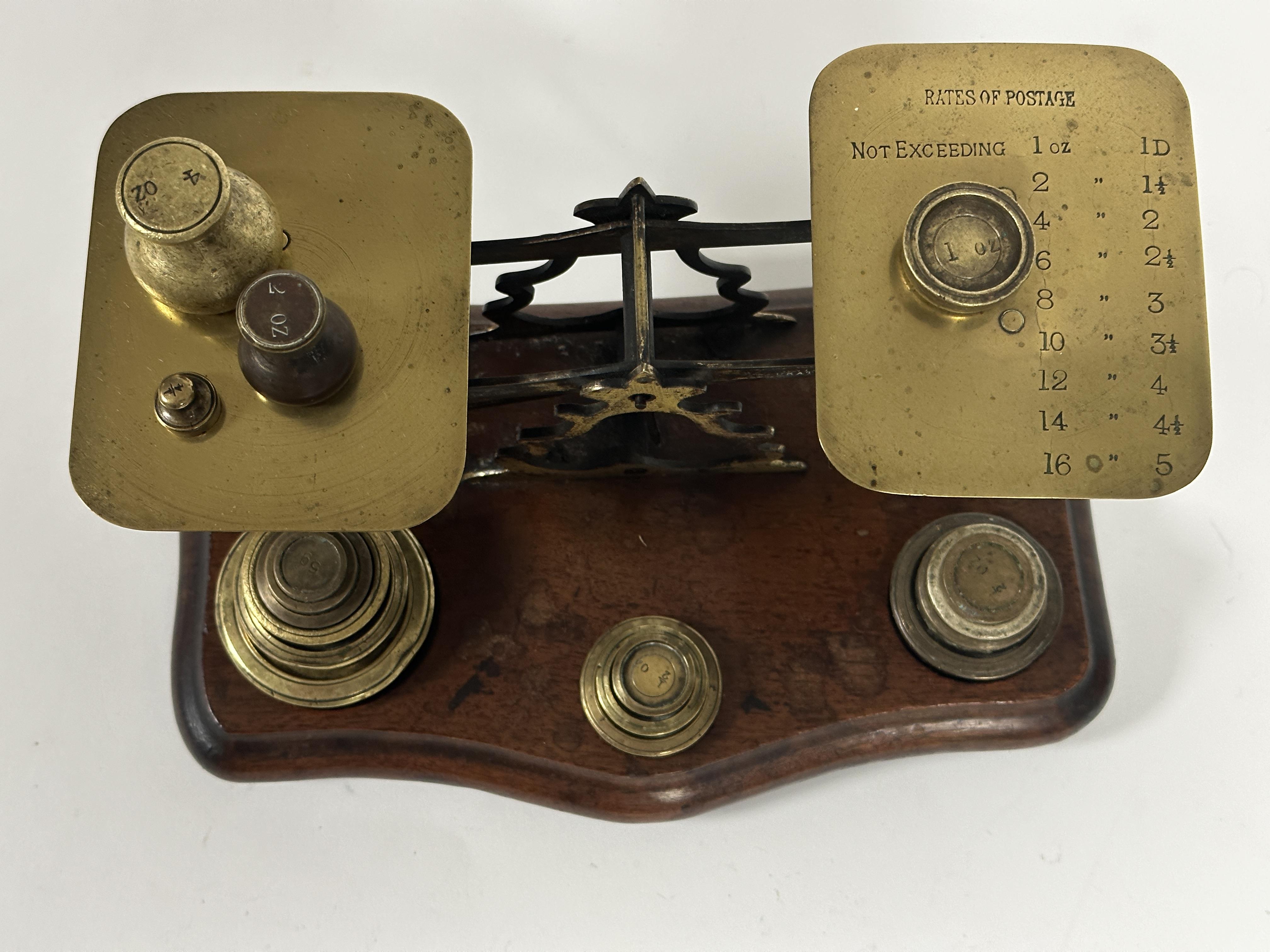 Edwardian brass set of postal scales with a collection of various brass weights on shaped mahogany - Image 2 of 2