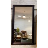 A large rectangular wall mirror in stained moulded pine frame 135cm x 74cm