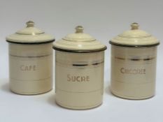 A trio of cream enamel store jars with cover, titles in gold including Cafe, Sucre and Chicoree. (