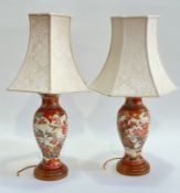 A pair of ceramic baluster shaped imari style table lamps, decorated with chrysanthemums and birds