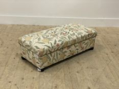 A traditional upholstered footstool, upholstered in William Morris 'Fruit' style transfer printed