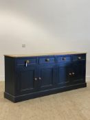 A Victorian style painted pine dresser base, fitted with four drawers and four panelled cupboard