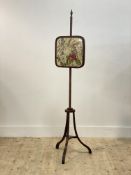 A 19th century mahogany and rosewood pole screen, the embroidered rise and fall banner worked in a