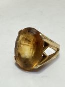A 18ct gold citrine dress ring, the oval stone set in high claw setting, (L x 1.9cm x W 1.4cm),