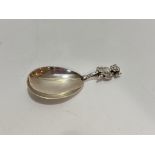 A Birmingham silver caddy spoon with horned mythical beast handle, (L x 8cm) Birmingham 1936. 22.8g