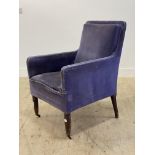An Edwardian easy chair, upholstered in blue velvet, raised on tapered supports with castors. H92cm,