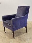 An Edwardian easy chair, upholstered in blue velvet, raised on tapered supports with castors. H92cm,