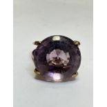 A 9ct gold circular Amethyst faceted cut dress ring mounted in four claw setting on double shank.(