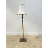 A mid 20th century stained ash lamp standard, the square tapered column raised on a square base,