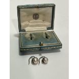 A pair of Edwardian yellow metal mounted natural pearl stud earrings of silver colour, one