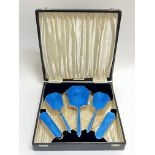 A boxed guilloche enamel on silver deposit dressing table set comprising two clothes brushes, two
