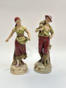 A pair of Royal Dux Bohemia porcelain figures, one of a man holding a hand plow and haystack on