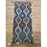 A Chobi Kilim runner rug of typical design, 148cm x 60cm
