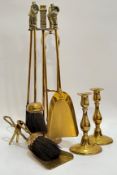 A group of brassware comprising a fire companion set modelled with Victorian chimney sweep figure