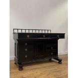 A late Victorian aesthetic period ebonised desk, the spindle gallery back over skivered top and