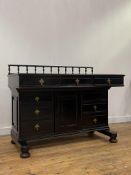 A late Victorian aesthetic period ebonised desk, the spindle gallery back over skivered top and