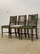 A set of three Edwardian walnut side chairs, with gadroon carved frames enclosing upholstered back