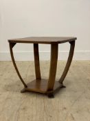 A 1930's Art Deco walnut lamp table, the square top with canted corners raised on four bowed