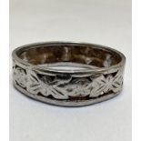 A platinum chased pierced leaf and flower head alternating wedding band, shows signs of heavy