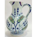 A large ceramic Isphahan water jug with Iznik style decoration of flowers and foliage (h- 28cm, w-