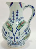 A large ceramic Isphahan water jug with Iznik style decoration of flowers and foliage (h- 28cm, w-