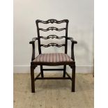 A 19th century mahogany fiddle back elbow chair, the back rails with anthemion motif over acanthus