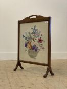 An Edwardian mahogany framed fire screen with embroidered panel worked in a floral design, H70cm