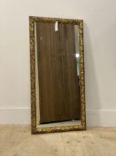 A 20thc decorative gilt composition mirror. (90cmx46cm)