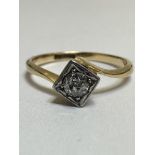 A 1920's 18ct gold and platinum solitaire diamond ring mounted in illusion setting on crossover