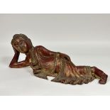 A Thai carved wood reclining Buddha figure, with red lacquer and gilt mirror decoration. (H x 20cm x