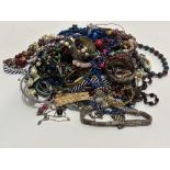 A large collection of costume jewellery including two gold plated bracelets, bead necklaces,