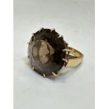 A yellow metal dress ring set large circular cut Cairngorm mounted in claw setting, (D x 2cm), O.