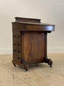 A Victorian inlaid walnut davenport, with stationary casket over skivered writing slant opening to a