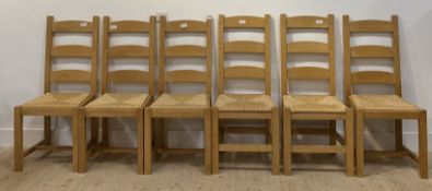 A set of six beech framed farmhouse style ladder back dining chairs, with paper cord seats, raised