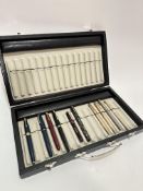 A modern pen case containing a collection of four Vintage Parker plastic coloured cased fountain