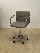 A Contemporary chrome plated and faux leather upholstered desk chair, on a rise and fall, swivel